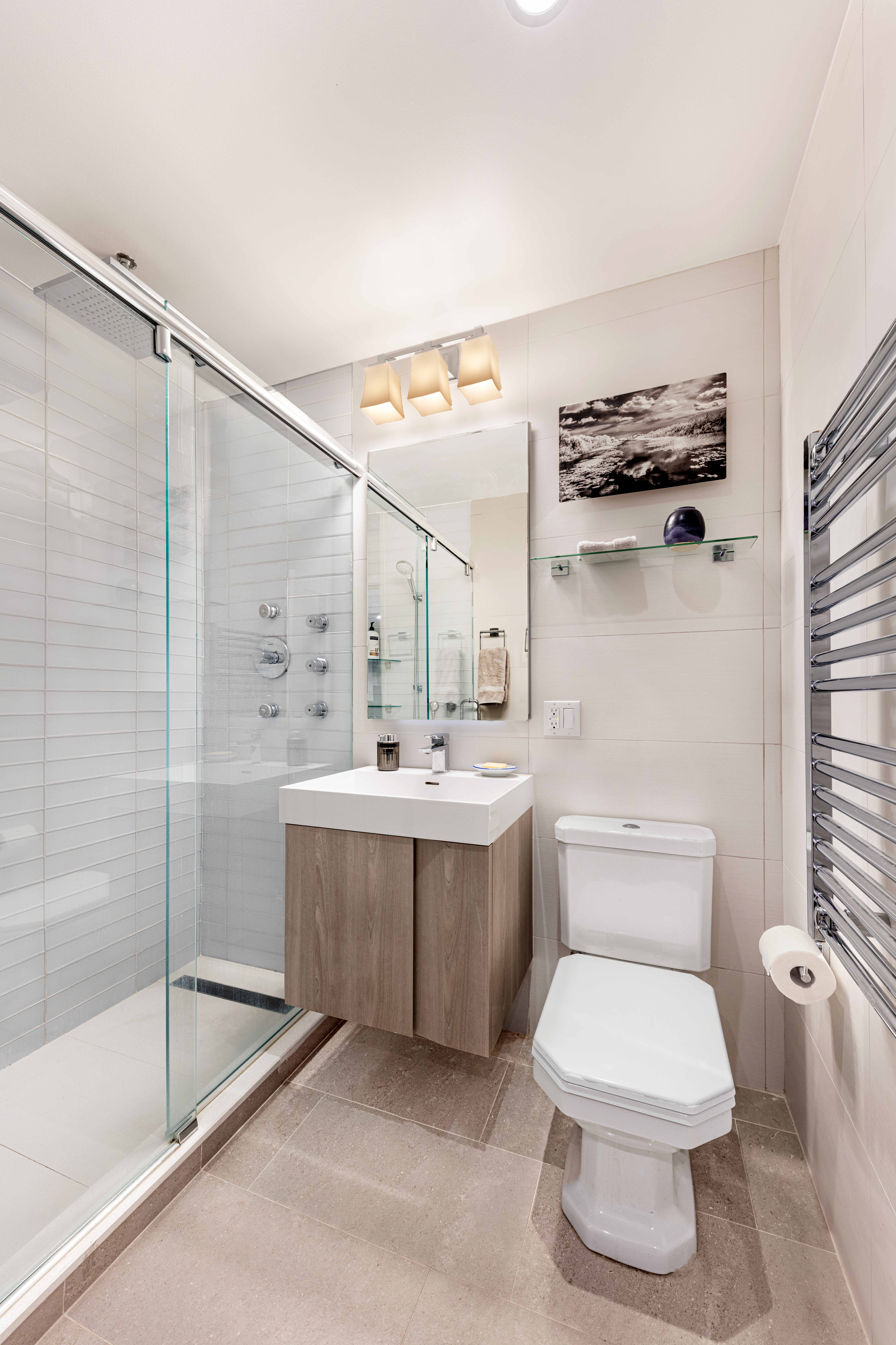 129 Barrow Street, Unit GA Manhattan, NY 10014 - Photo 15 of 17 a bathroom with a sink mirror toilet and bathtub