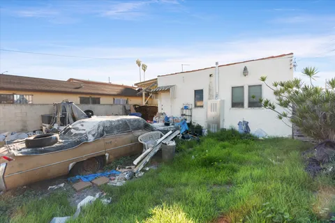 a view of a patio with table and chairs and potted plants