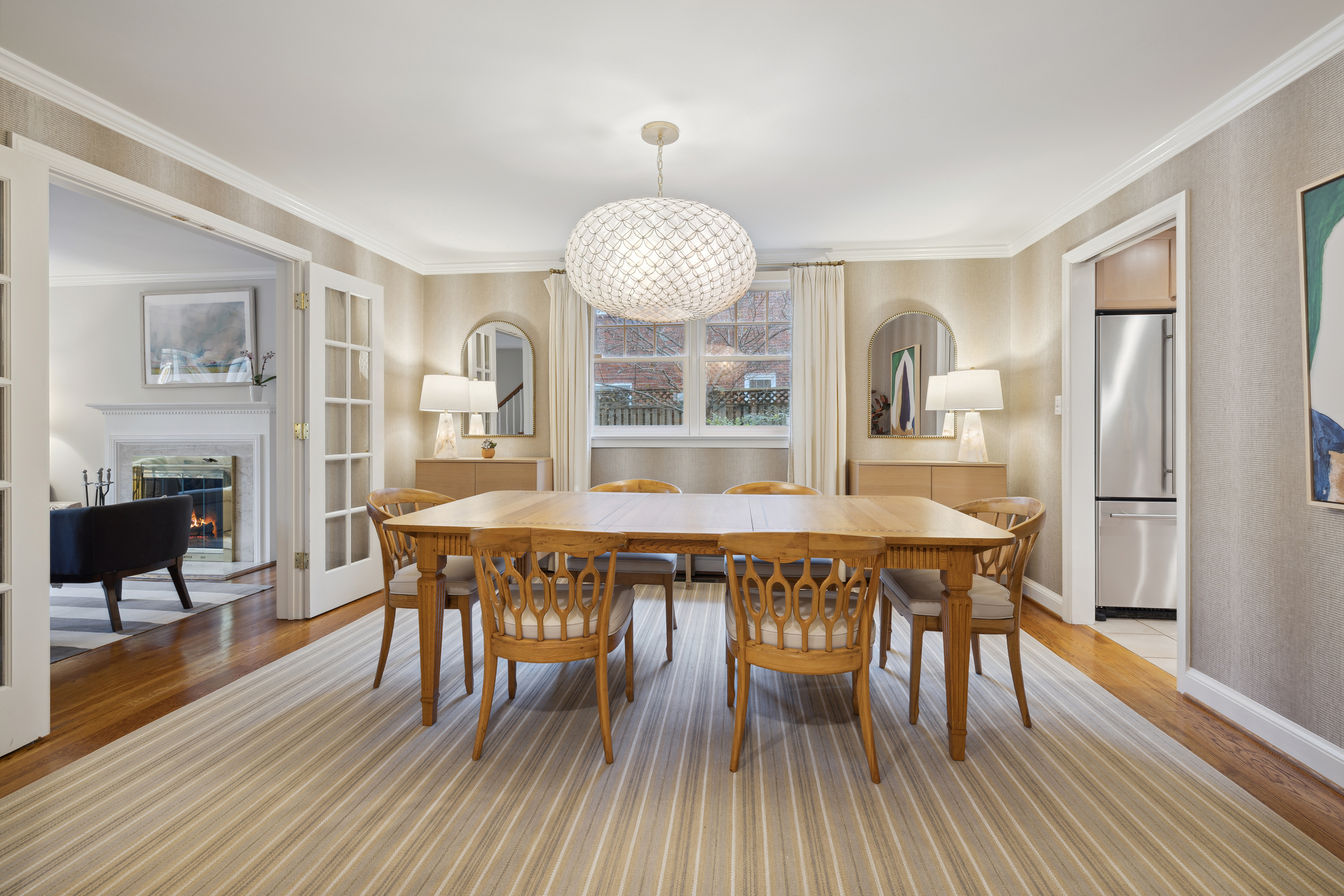 5016 Allan Road Bethesda, MD 20816 - Photo 3 of 4 a dining room with wooden floor a chandelier a wooden table and chairs