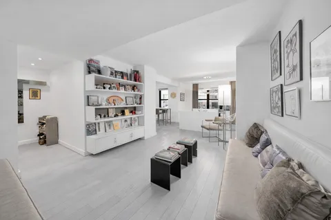 a living room with furniture and a book shelf