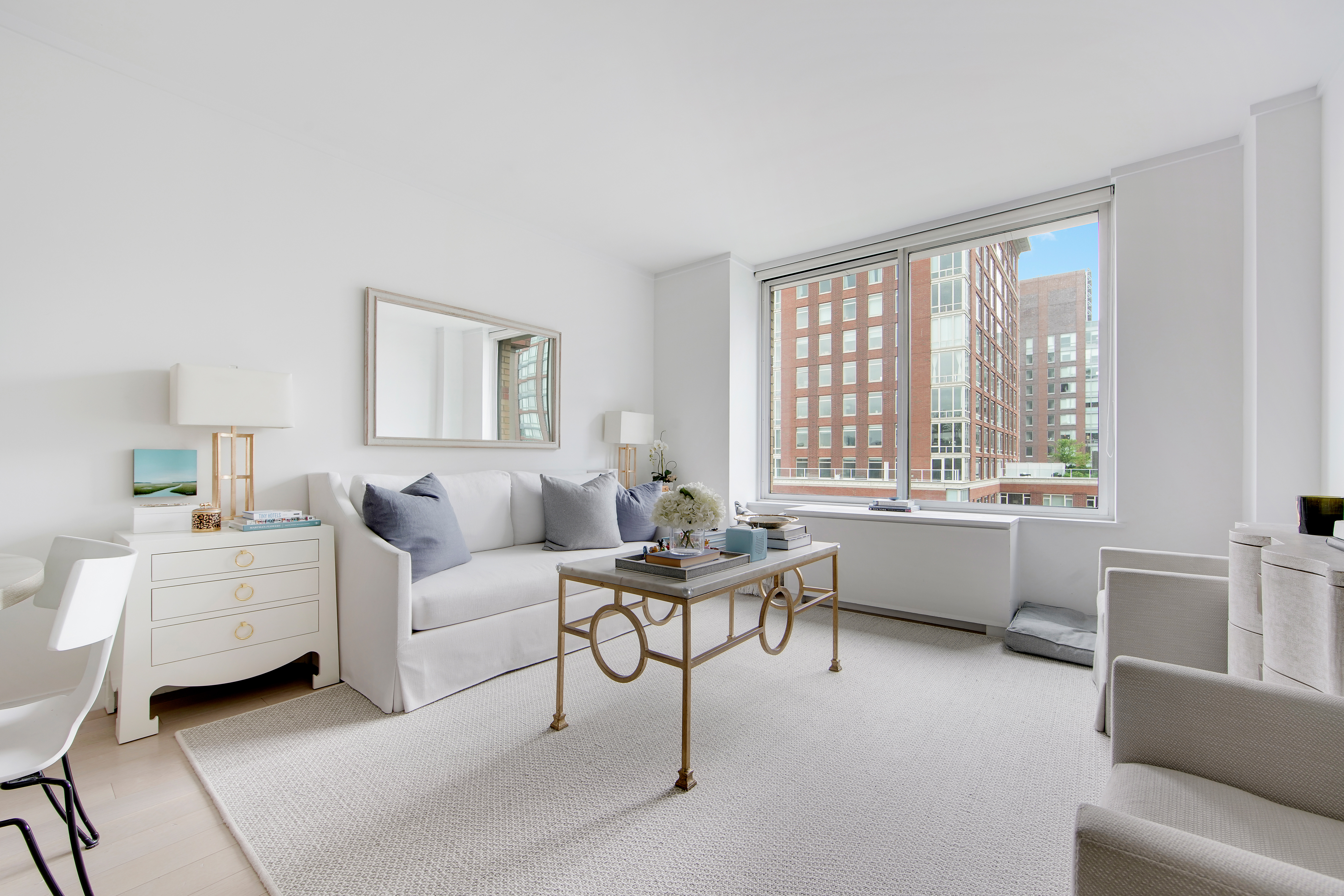212 Warren Street, Unit 17S Manhattan, NY 10282 - Photo 2 of 15 a living room with furniture and a large window