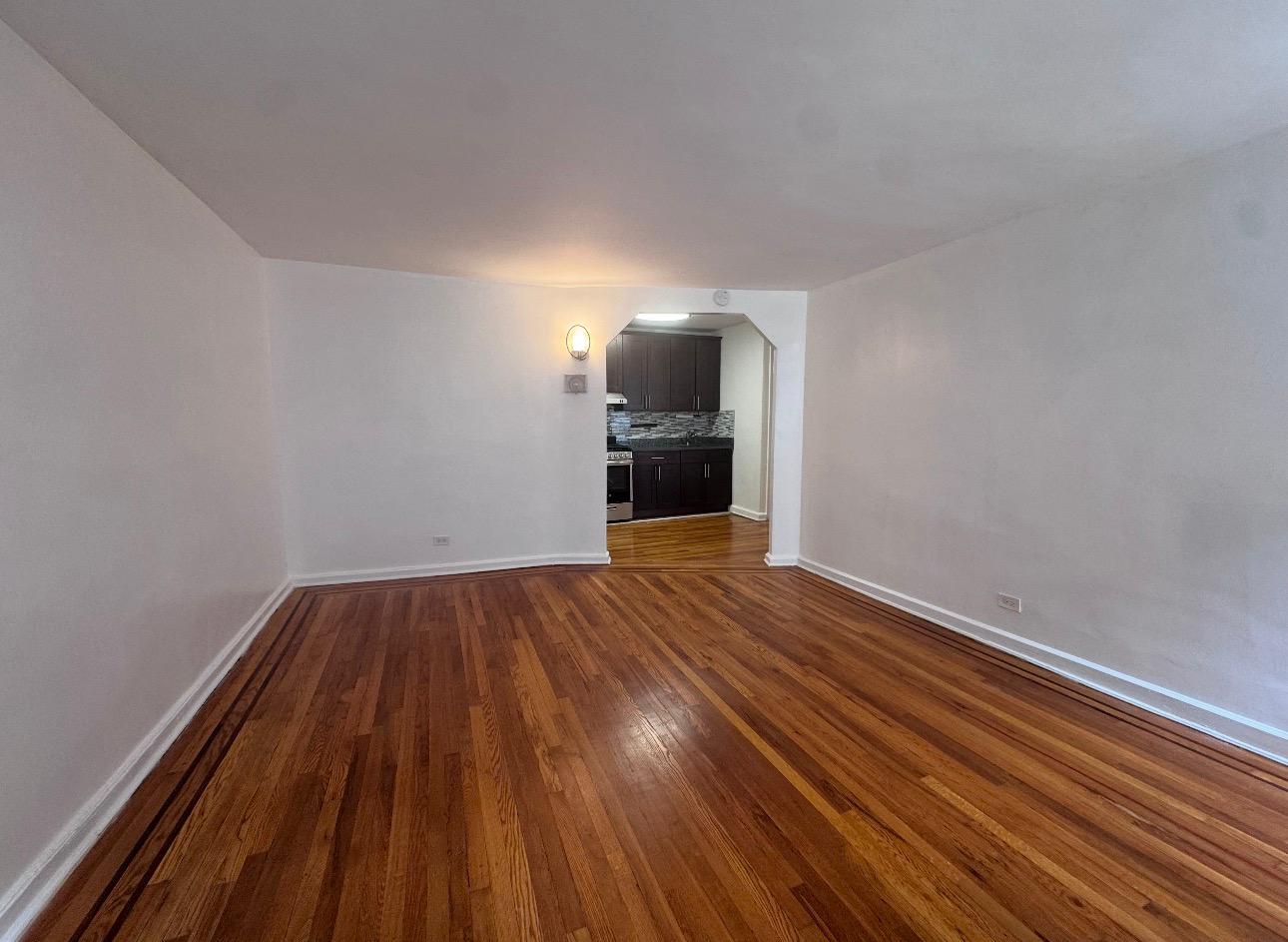 123 Avenue A, Unit 4 Manhattan, NY 10009 - Photo 4 of 14 a view of empty room with wooden floor