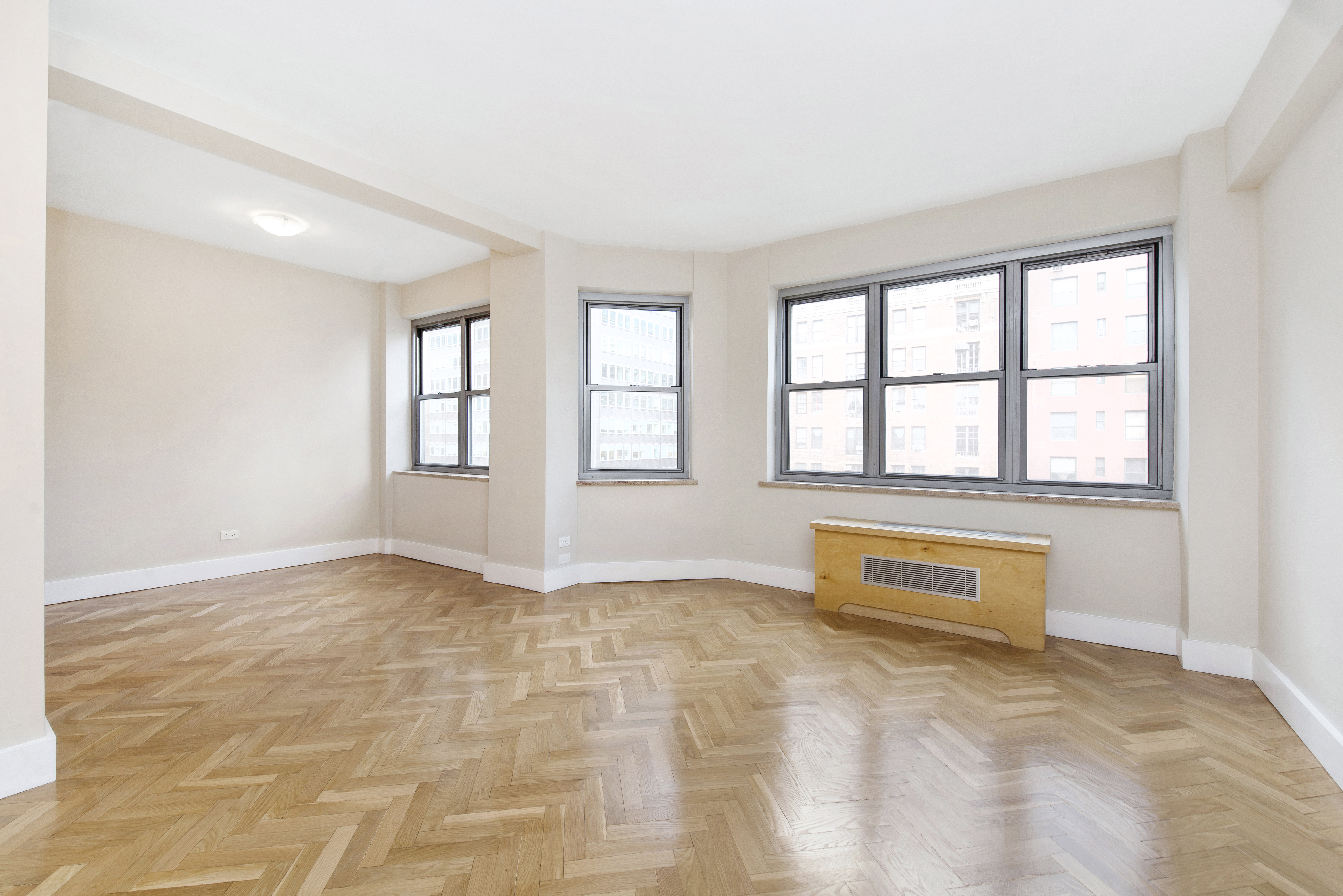 80 Park Avenue, Unit 9L Manhattan, NY 10016 - Photo 3 of 10 an empty room with windows