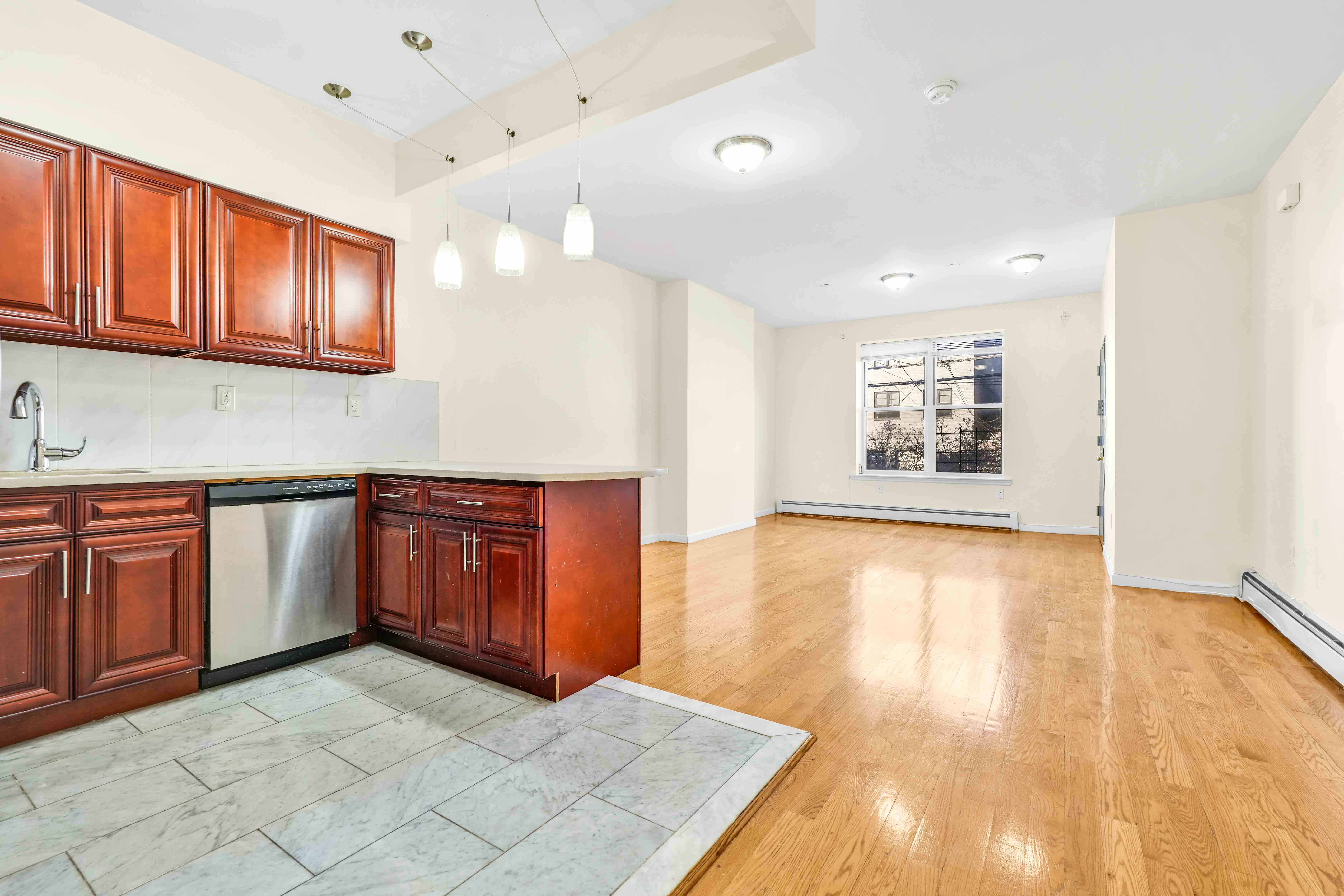 1892 Bergen Street, Unit 2 Brooklyn, NY 11233 - Photo 19 of 24 a view of a kitchen with a sink cabinet and a window