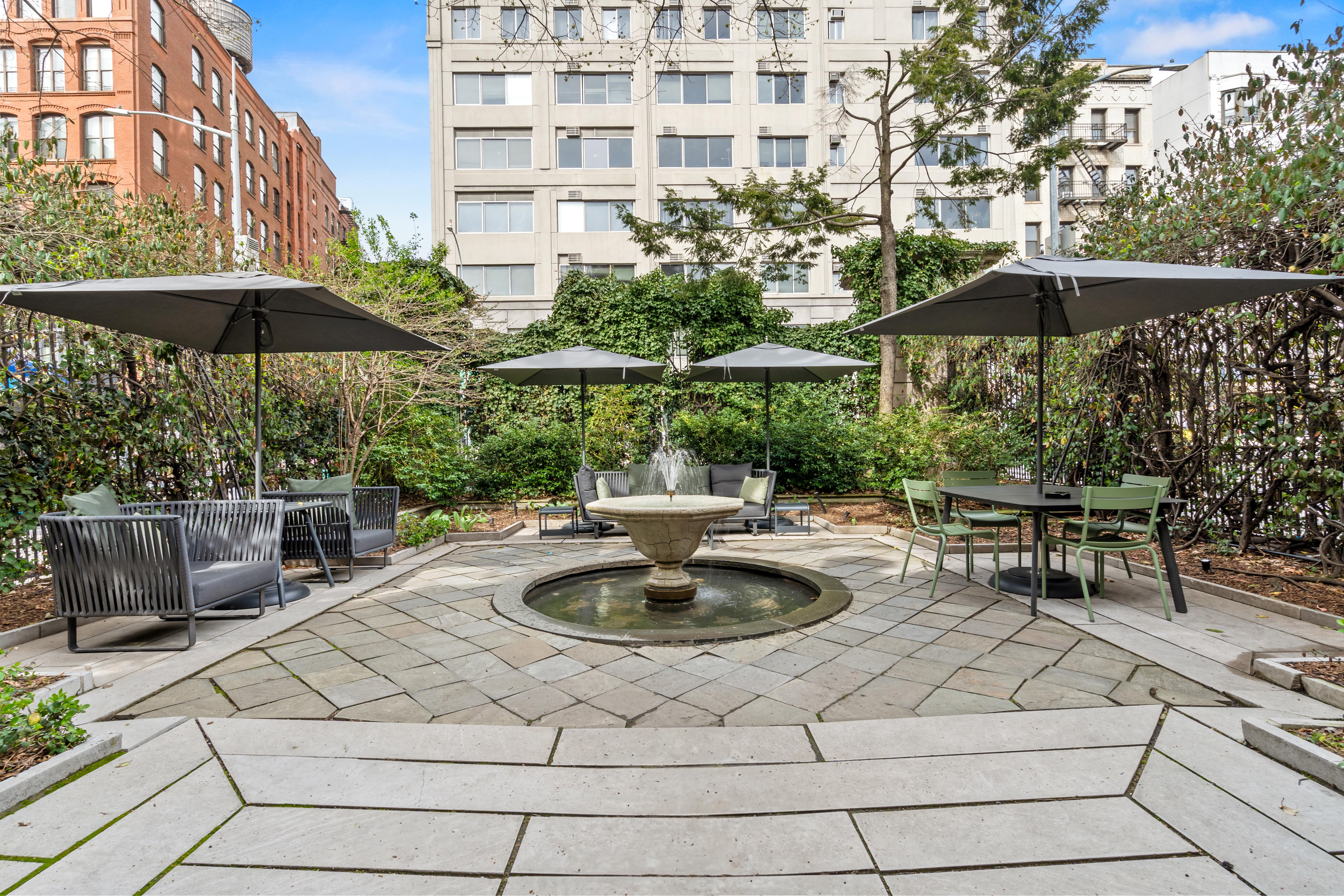 240 Centre Street, Unit 2N Manhattan, NY 10013 - Photo 14 of 16 a view of a patio with a table and chairs under an umbrella
