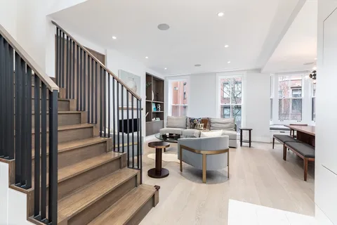 a living room with lots of furniture and white walls