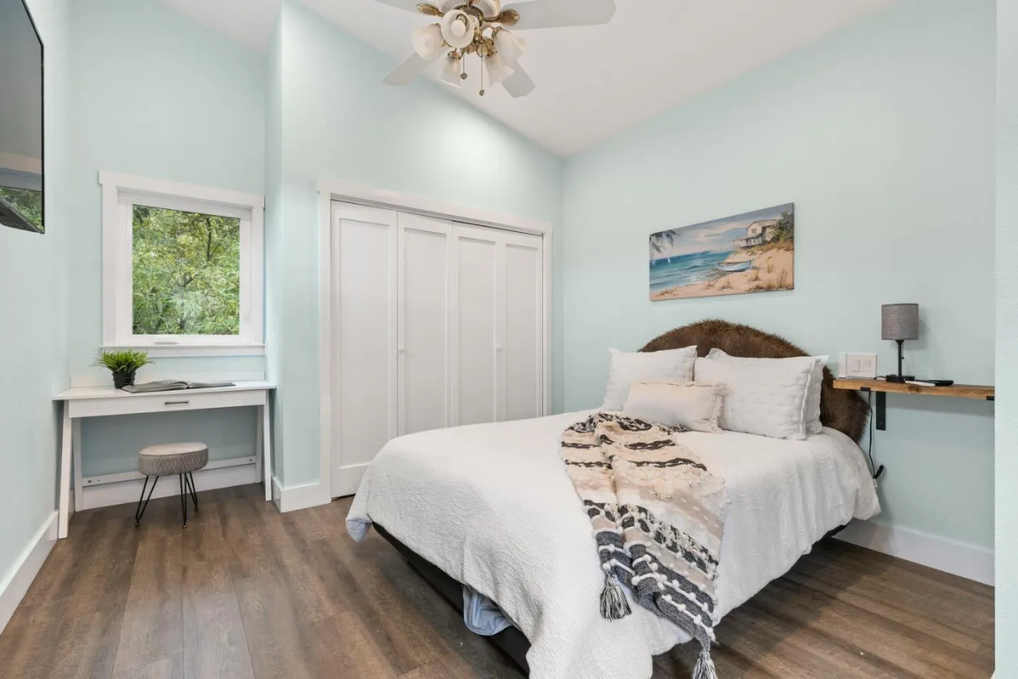 a bedroom with a bed and flat screen tv