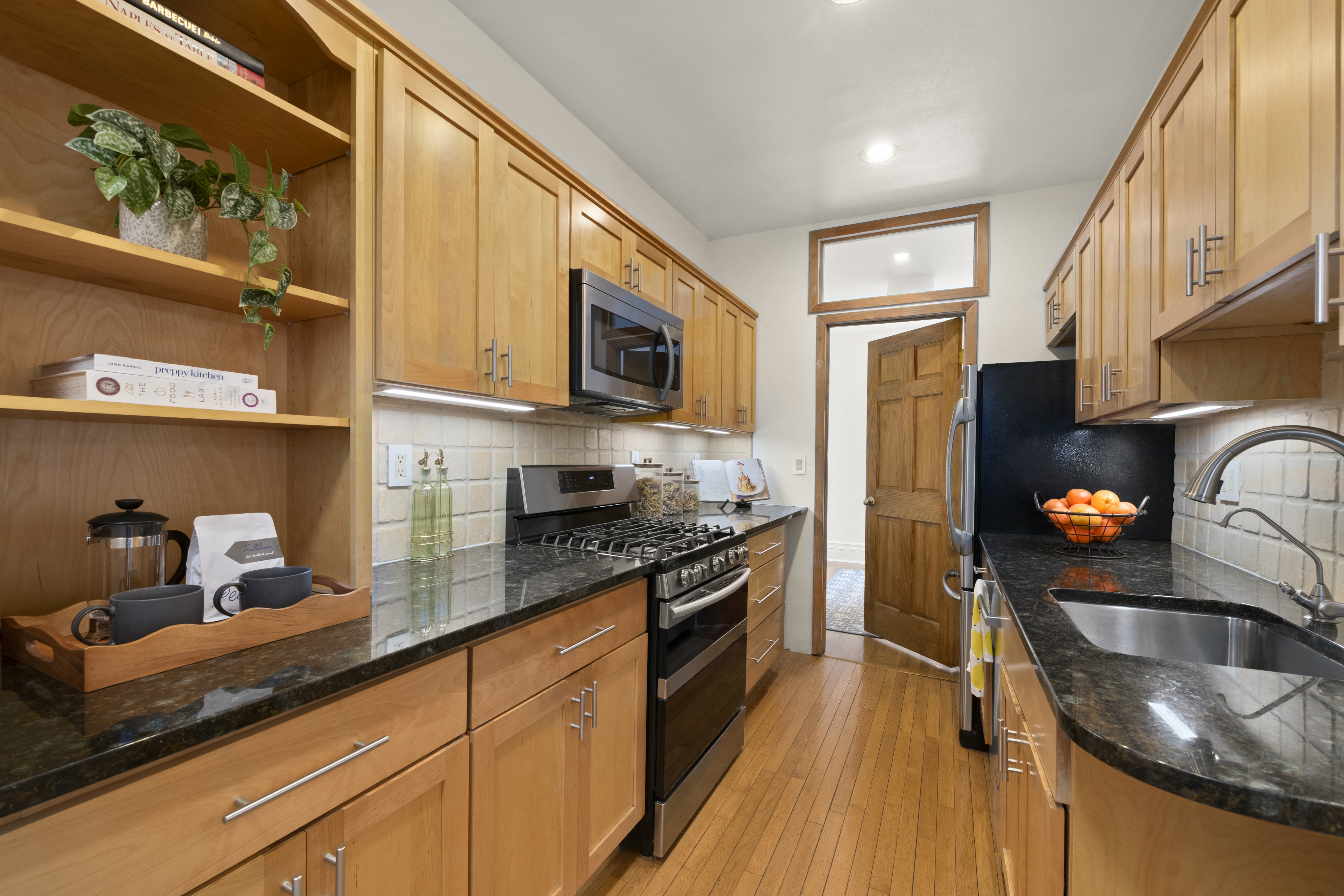 3875 Waldo Avenue, Unit 6E Bronx, NY 10463 - Photo 7 of 11 a kitchen with stainless steel appliances granite countertop a sink a stove and a refrigerator