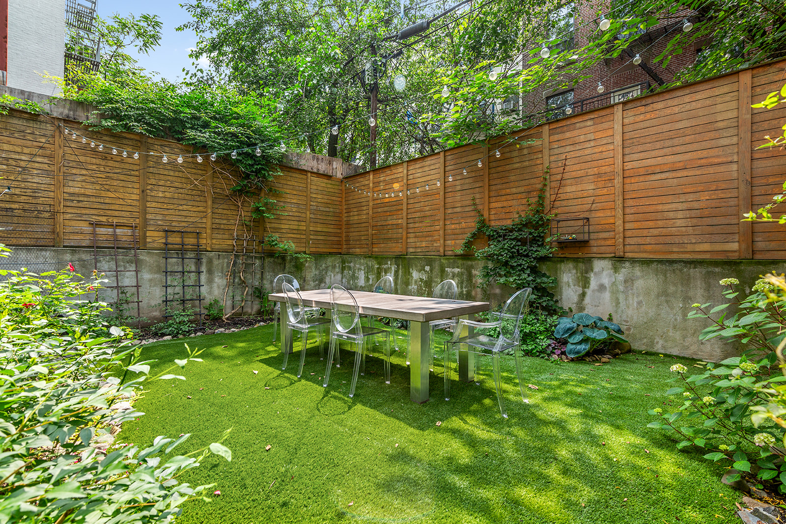 120 Pulaski Street, Unit 1B Brooklyn, NY 11206 - Photo 10 of 13 a backyard of a house with table and chairs
