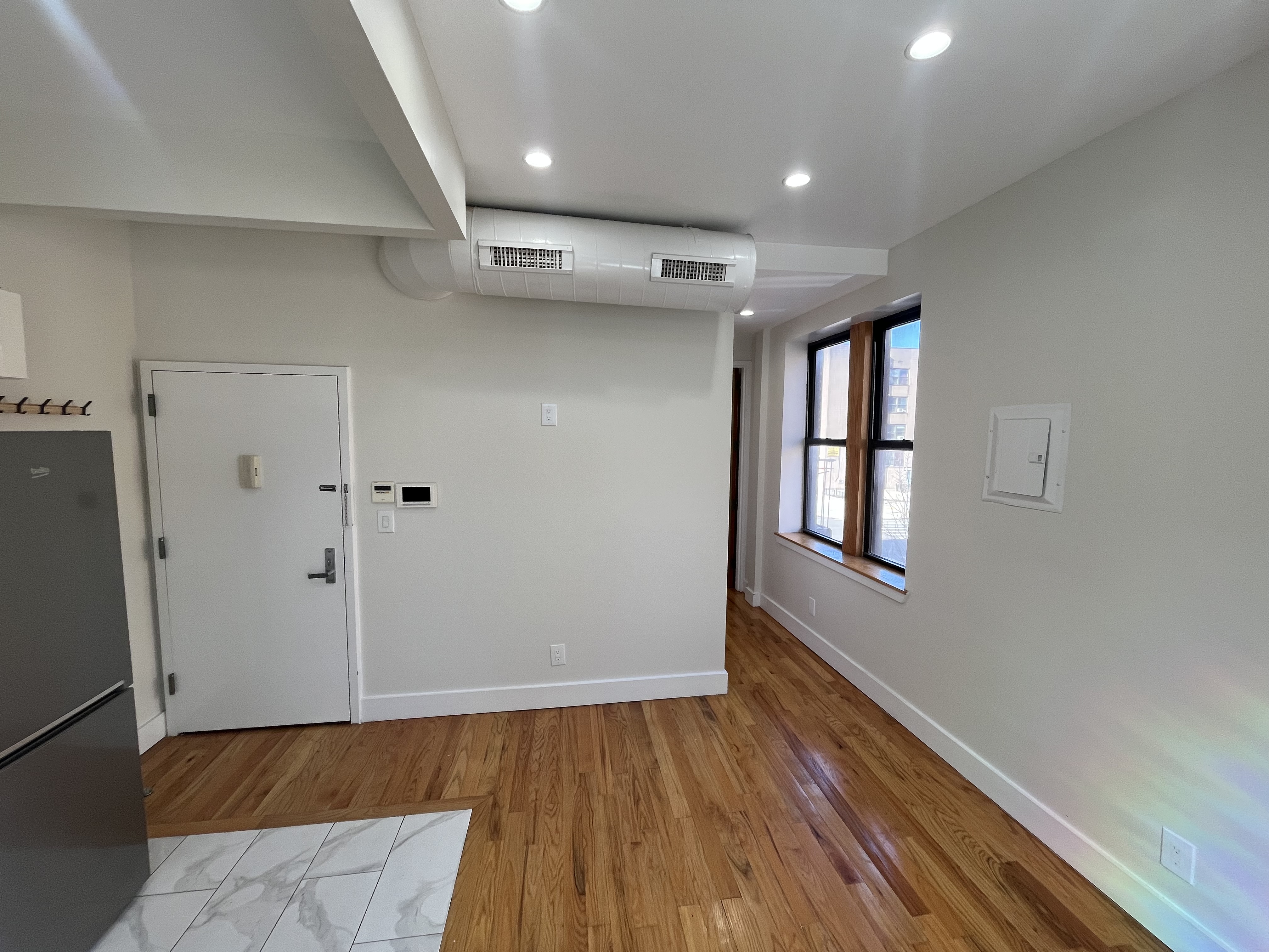 610 Monroe Street, Unit 2R Brooklyn, NY 11221 - Photo 3 of 6 wooden floor in an empty room with a window