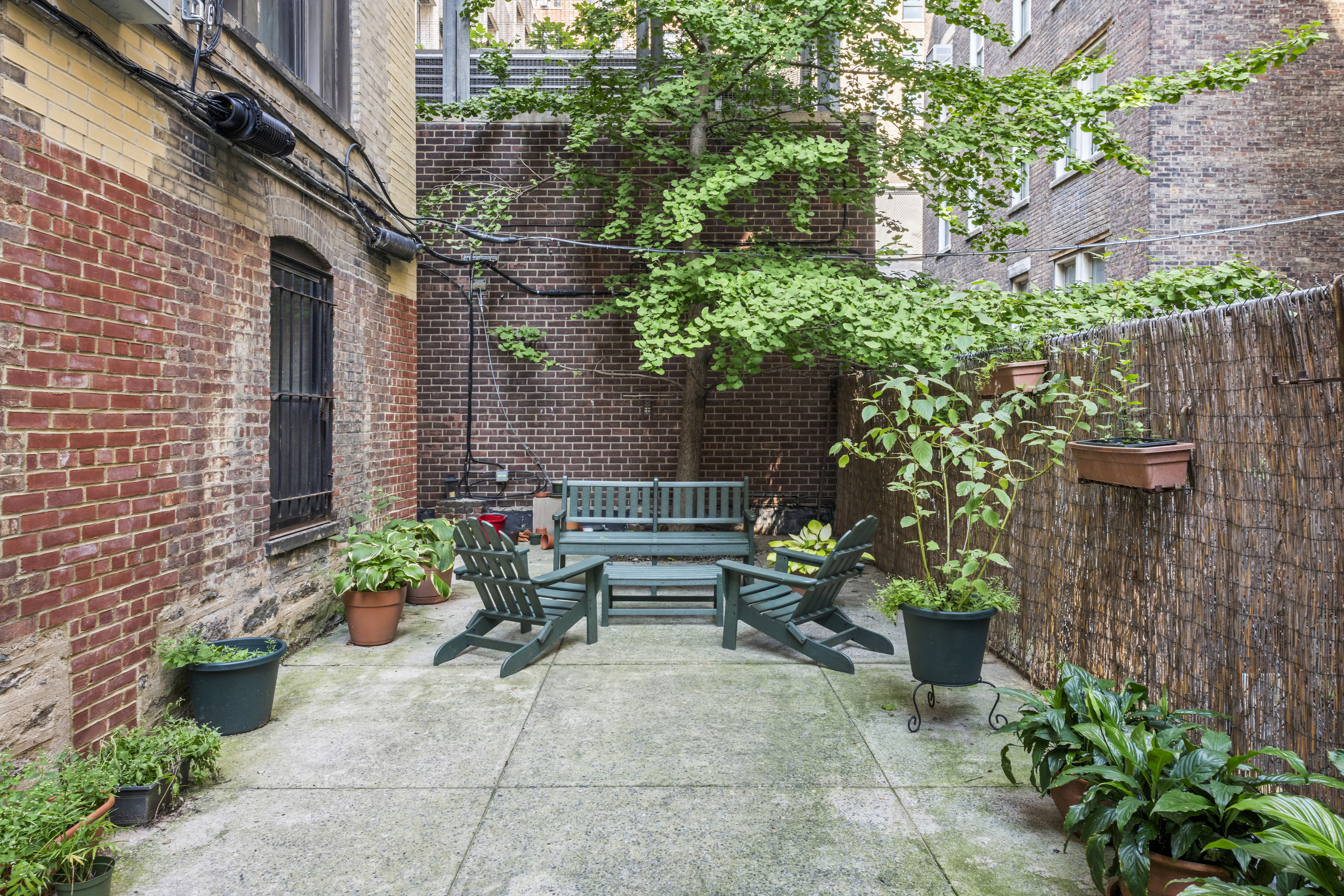609 West 114th Street, Unit 2 Manhattan, NY 10025 - Photo 15 of 16 a view of a backyard with plants and a bench