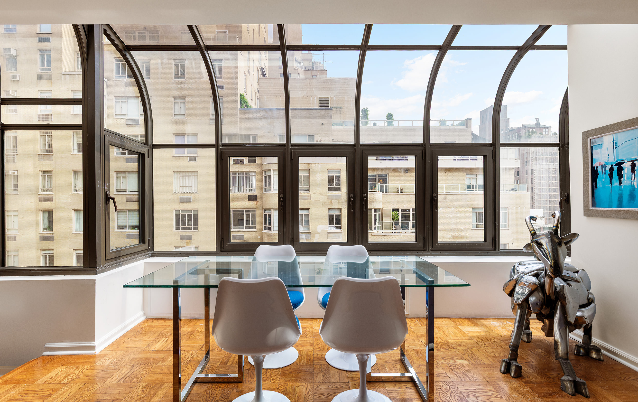 860 5th Avenue, Unit 11E Manhattan, NY 10065 - Photo 2 of 9 a view of a dining room with furniture window and wooden floor