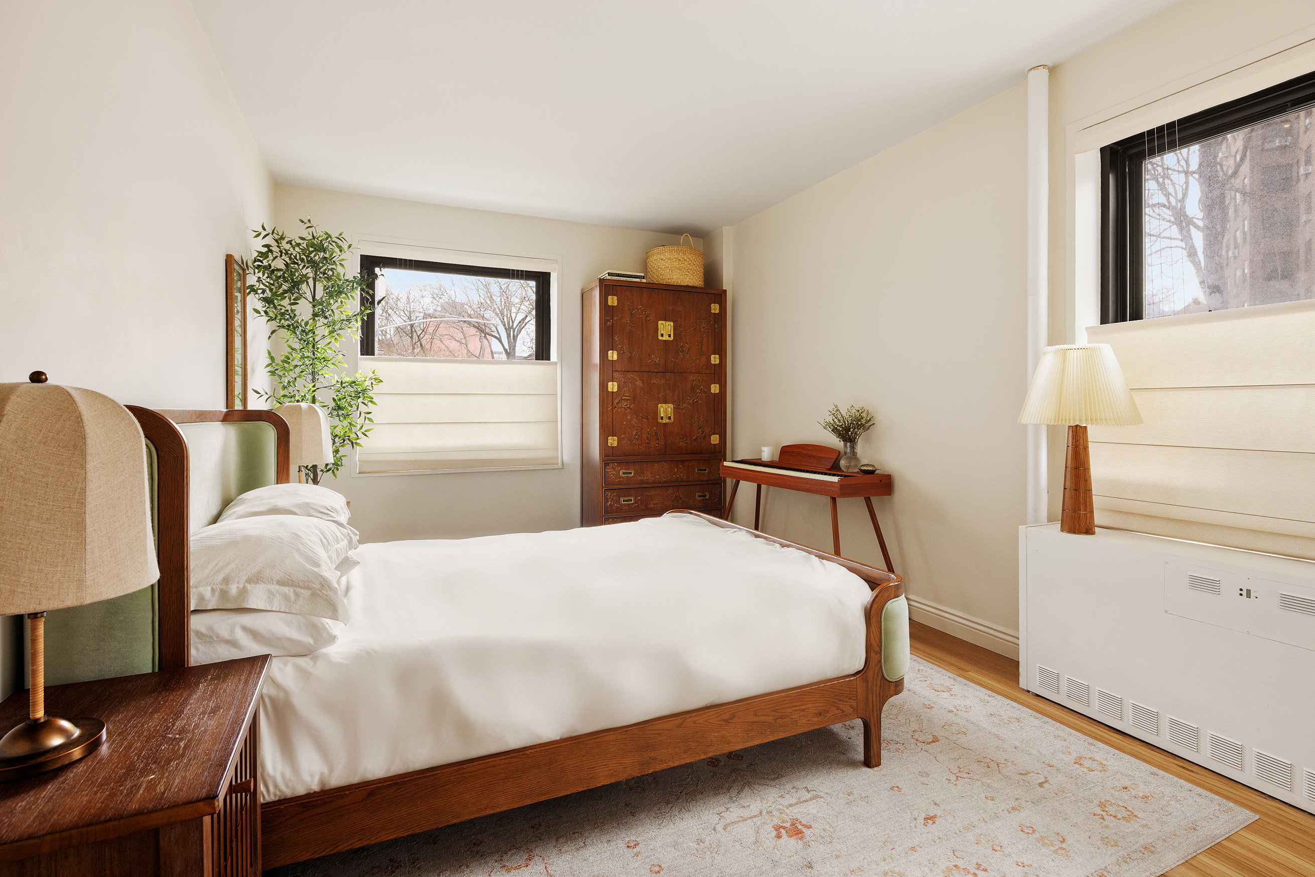 201 Clinton Avenue, Unit 1G Brooklyn, NY 11205 - Photo 6 of 9 a bedroom with a bed and wooden floor