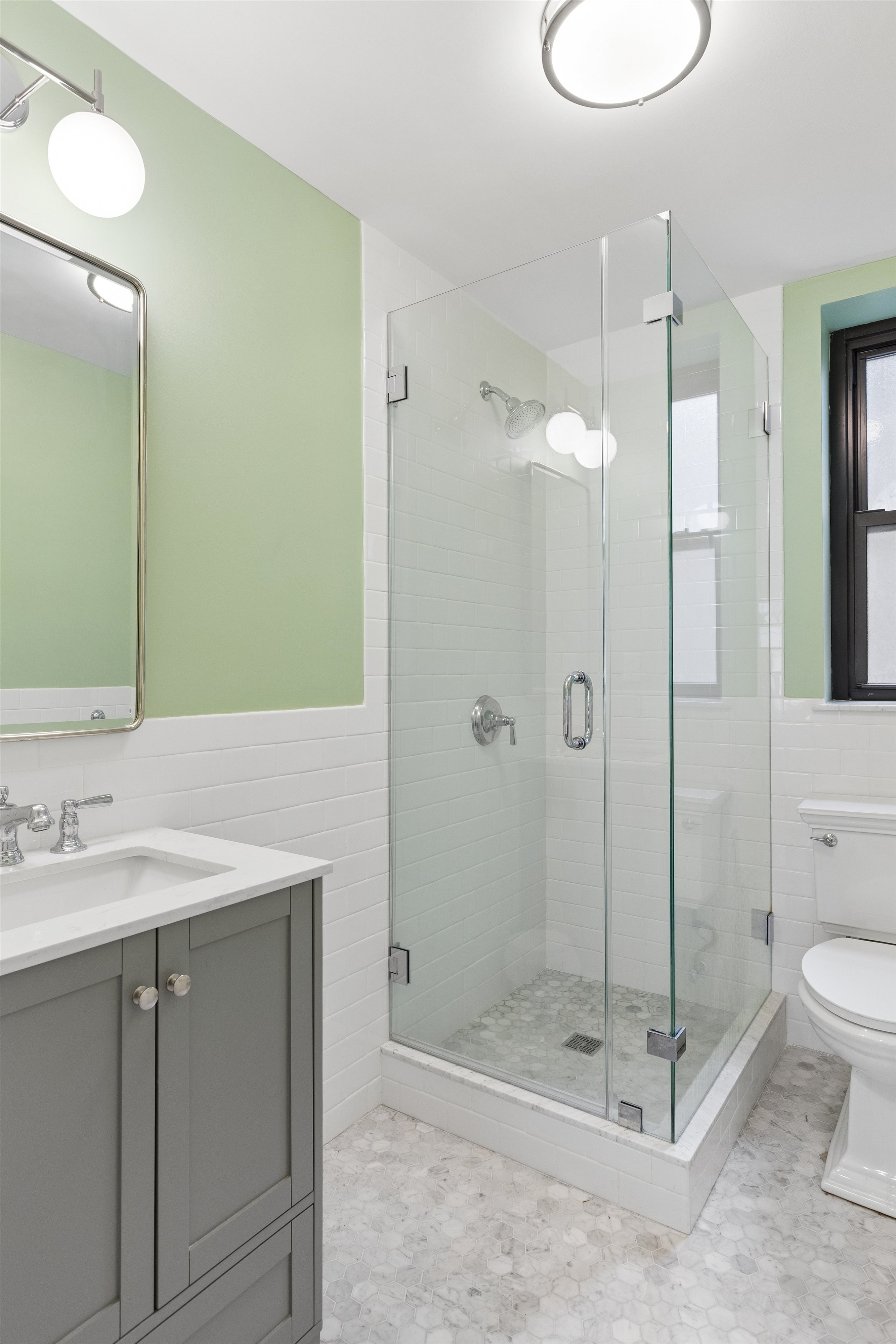 444 East 52nd Street, Unit 3C Manhattan, NY 10022 - Photo 12 of 19 a bathroom with a shower a sink and toilet