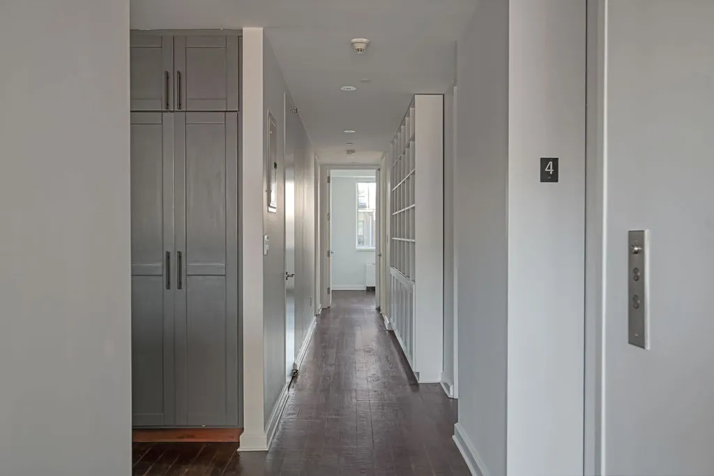 a view of a hallway with wooden floor