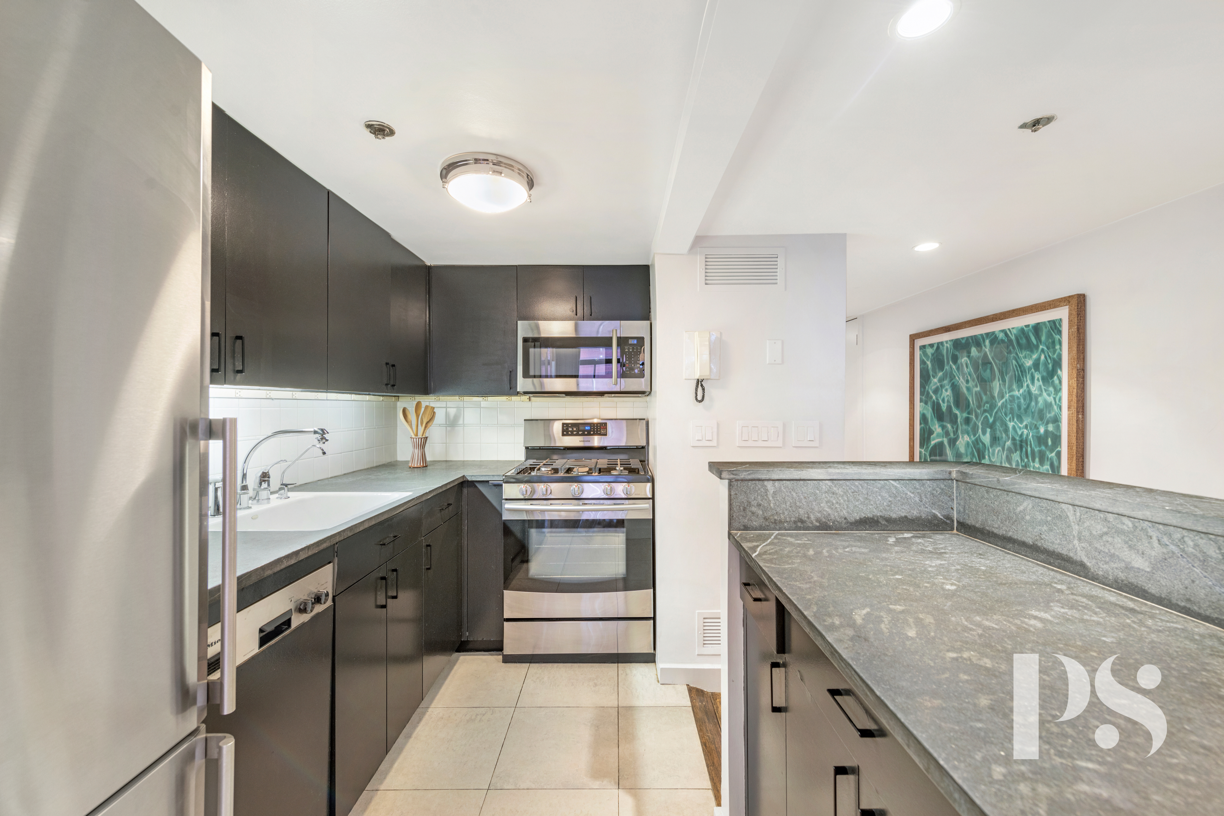 67 East 11th Street, Unit 517 Manhattan, NY 10003 - Photo 6 of 13 a kitchen with a stove a sink and a refrigerator