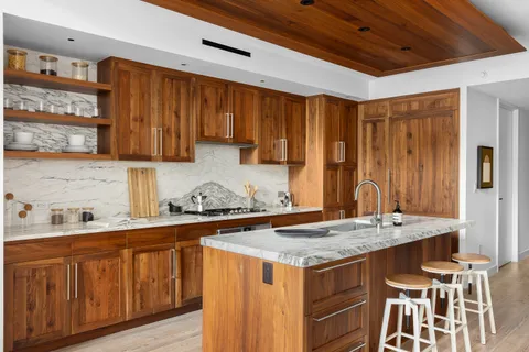 a kitchen with granite countertop a sink stove and cabinets