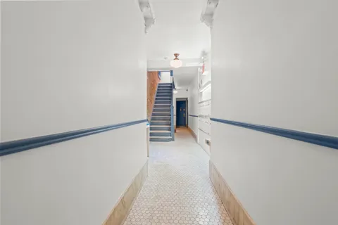 a view of a hallway with stairs