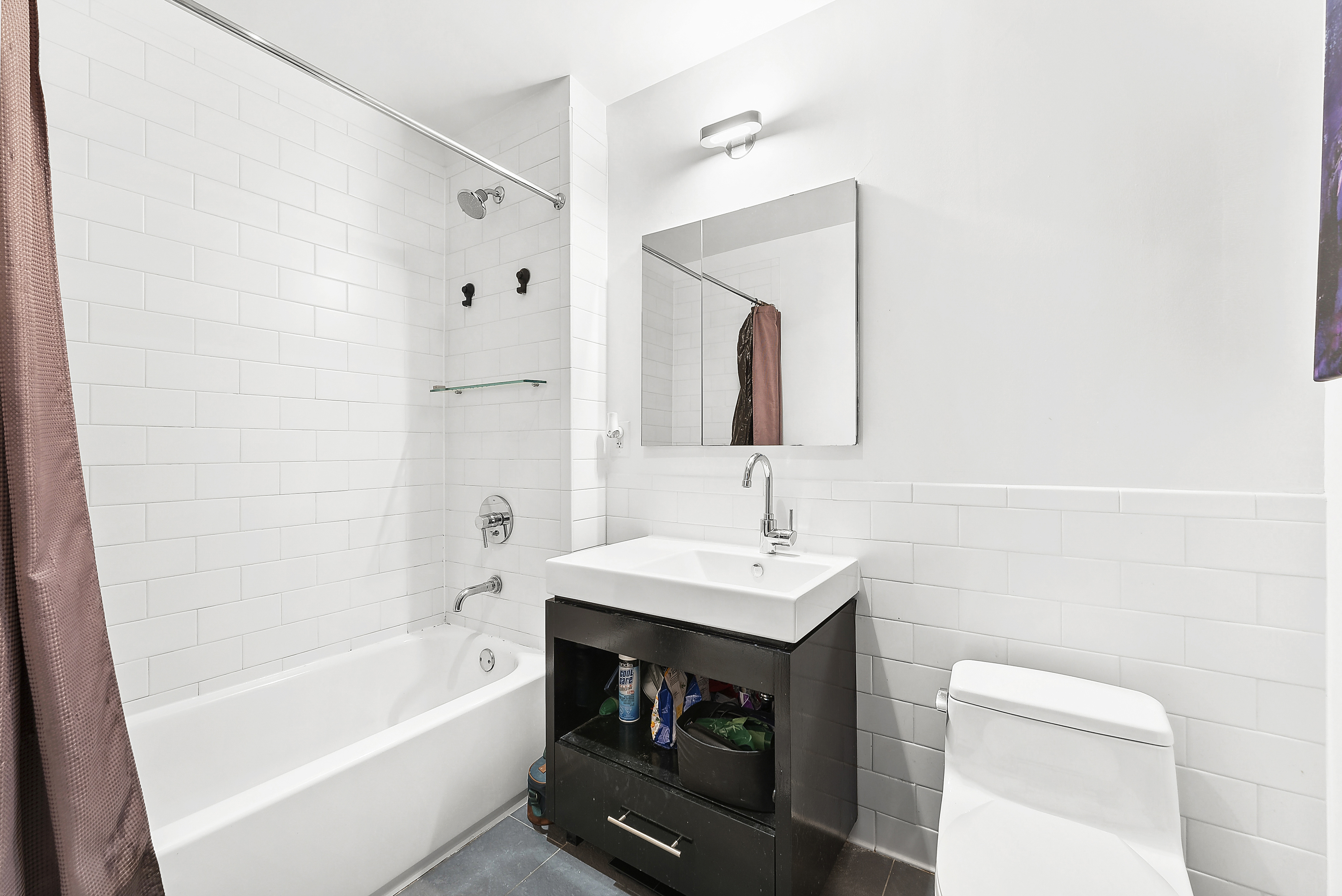 550 West 54th Street, Unit 1030 Manhattan, NY 10019 - Photo 4 of 5 a bathroom with a sink toilet and bathtub