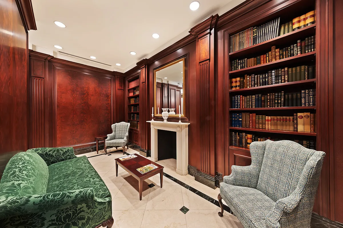 351 East 51st Street, Unit PH5B Manhattan, NY 10022 - Photo 10 of 13 a living room with furniture a bookshelf and a book shelf