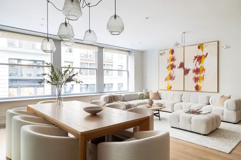 a dining room with furniture and window