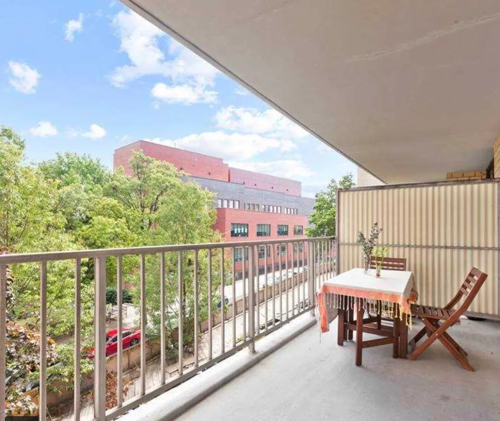 a balcony with furniture and a potted plant