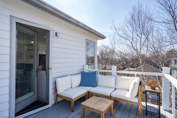 a roof deck with a table and chairs