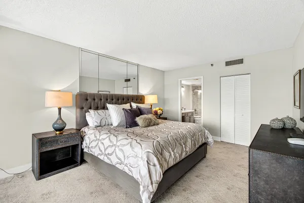 a bedroom with a bed and a lamp
