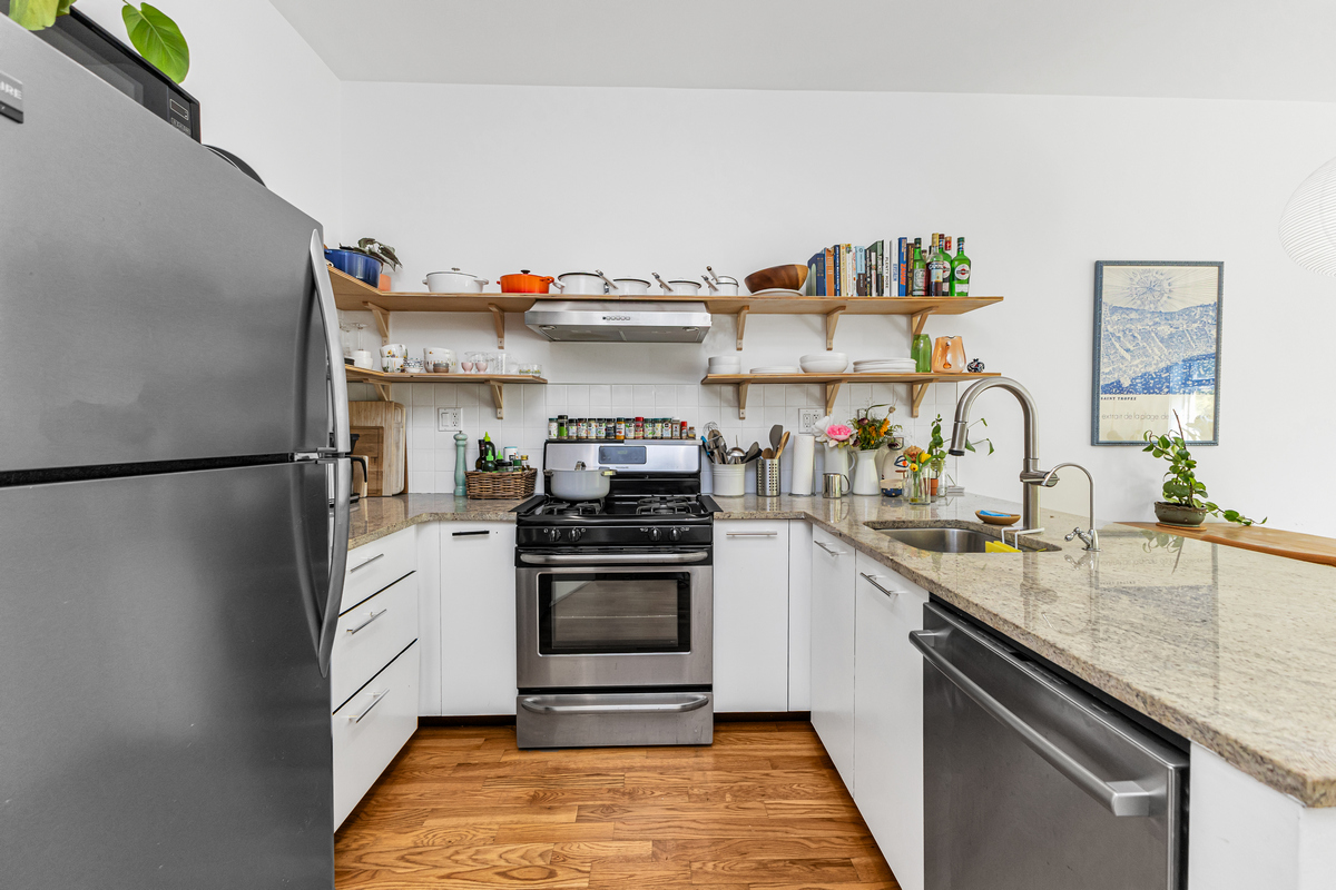 325 Greene Avenue, Unit 3B Brooklyn, NY 11238 - Photo 5 of 7 a kitchen with stainless steel appliances granite countertop a sink stove and refrigerator