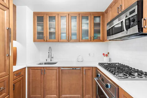 a kitchen with stainless steel appliances granite countertop a stove and a sink