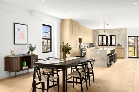 a view of a dining room with furniture and chandelier
