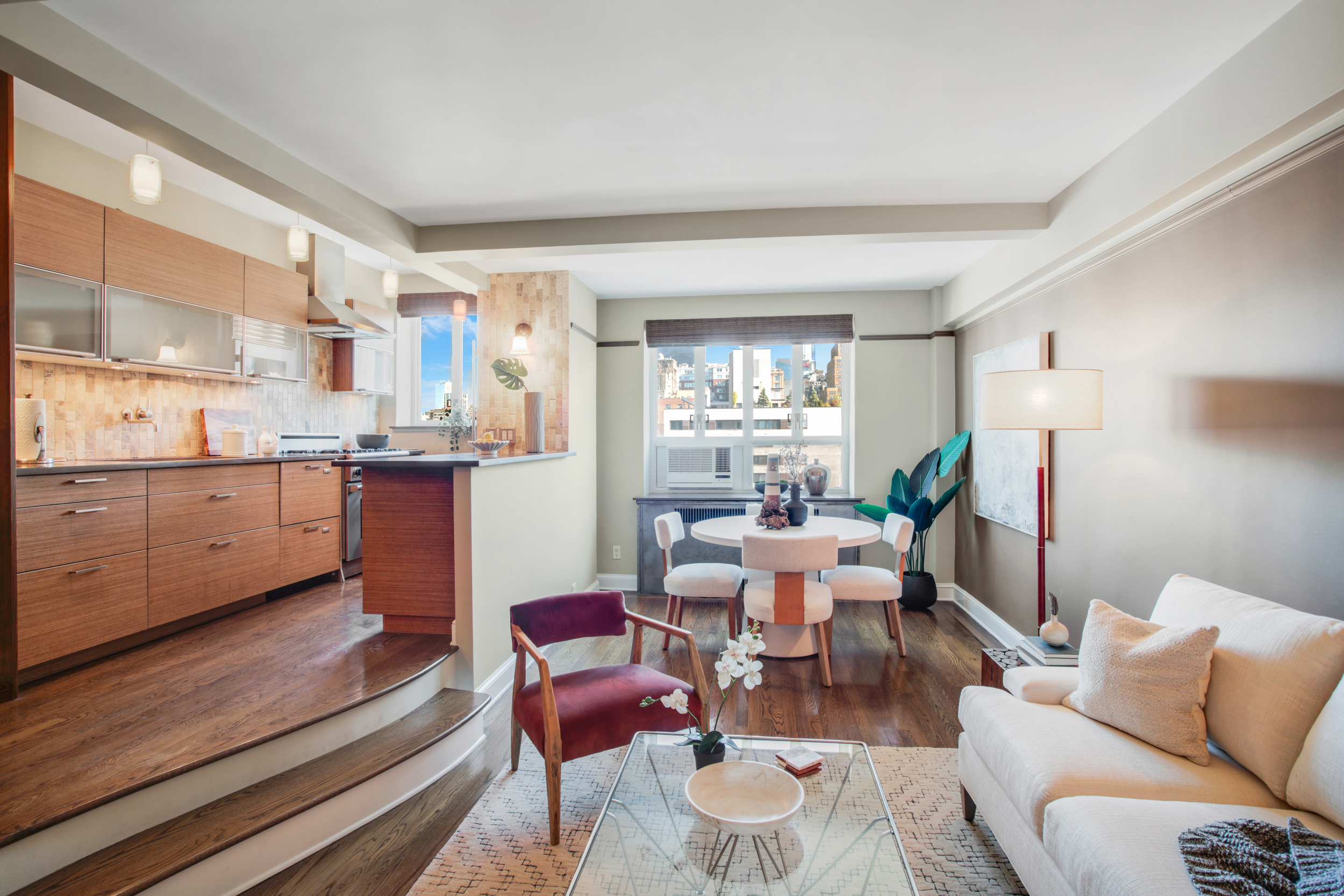 200 West 20th Street, Unit 1409/10 Manhattan, NY 10011 - Photo 5 of 15 a living room with stainless steel appliances kitchen island granite countertop furniture and a large window