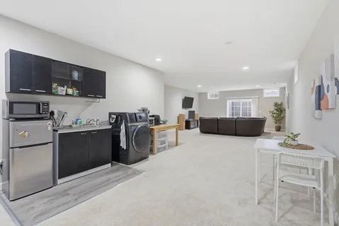 a front view of a house with a yard table and chairs