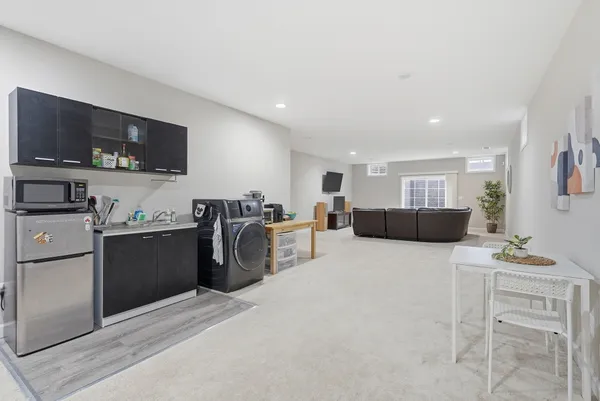 a view of a patio with couches chairs and wooden floor