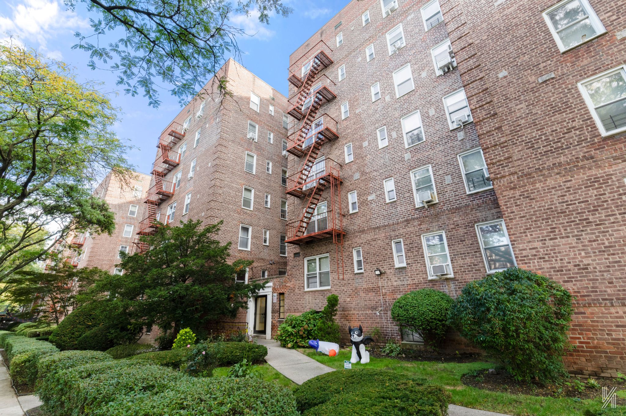 39-55 51st Street, Unit 3G Queens, NY 11377 - Photo 17 of 18 a front view of a multi story building with yard