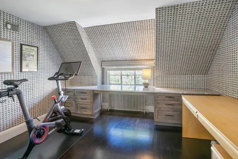 a room with gym equipment and a large window