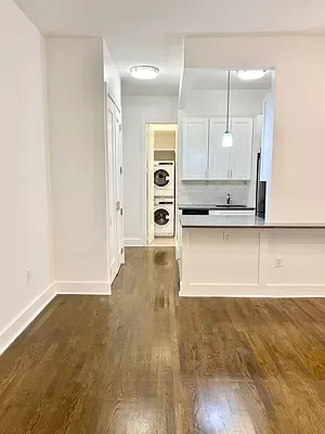 a view of a kitchen with a sink hardwood floor and a counter top space