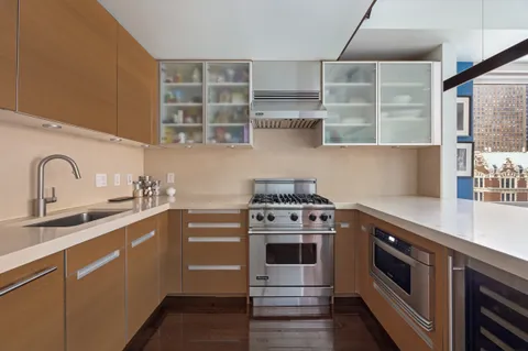 a kitchen with stainless steel appliances a stove sink and cabinets