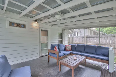 a living room with furniture with wooden floor and iron walls
