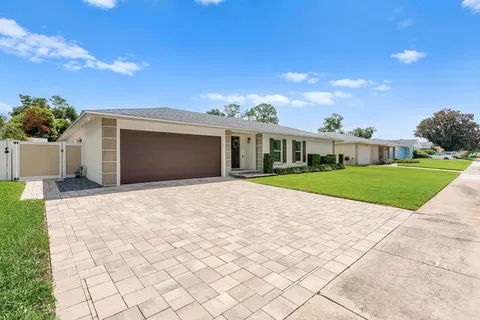 a view of white house with a yard