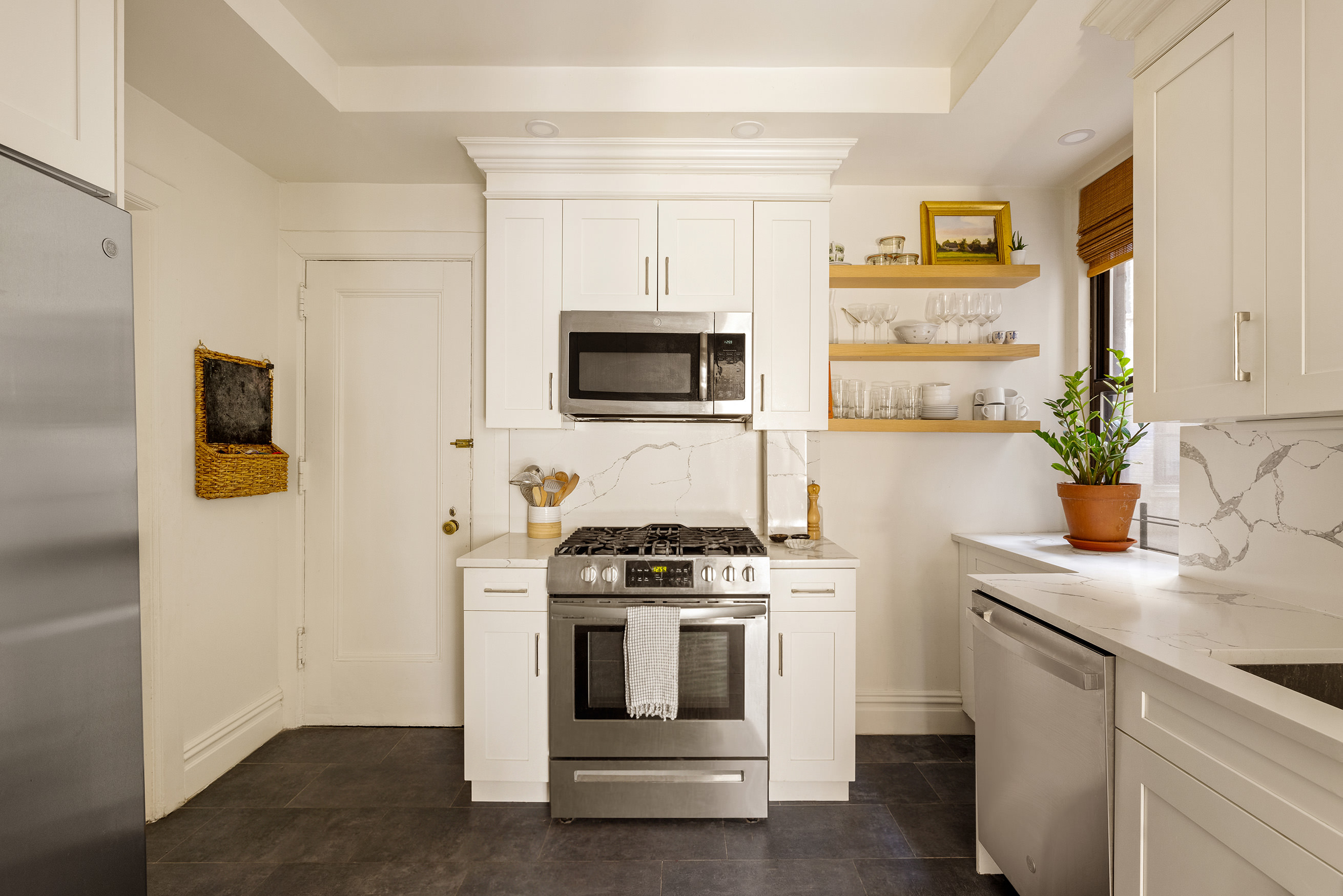 114 East 84th Street, Unit 3C Manhattan, NY 10028 - Photo 6 of 15 a kitchen with a stove and a sink