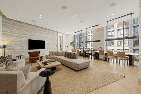 a living room with furniture a flat screen tv and a large window