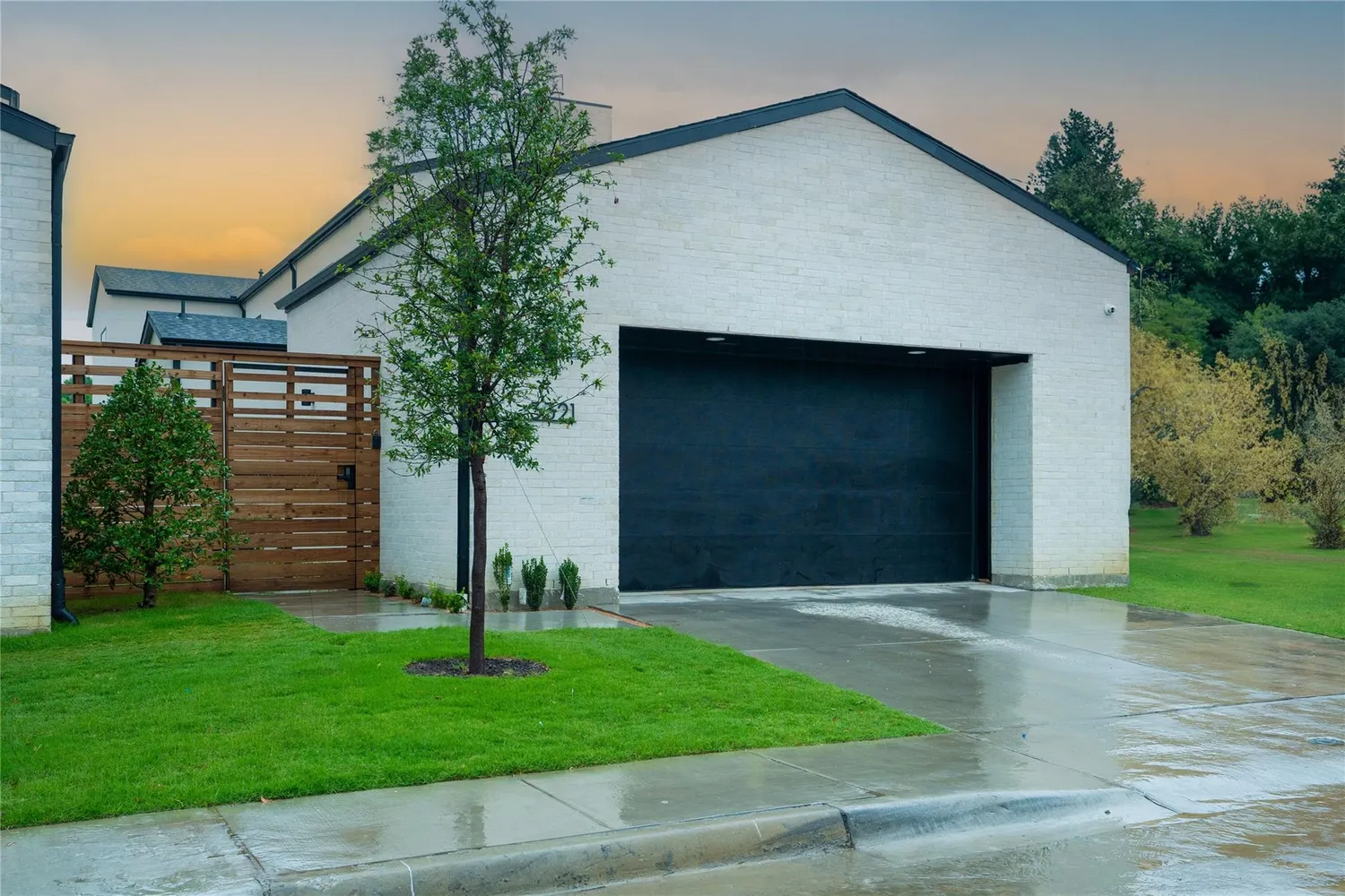 a front view of a house with a garden and plants
