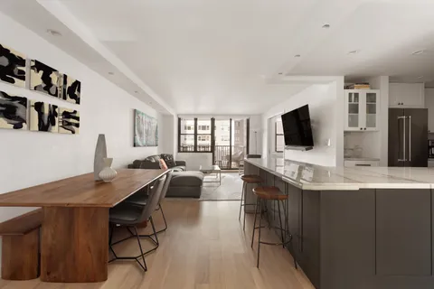 a view of a dining room with furniture and a flat screen tv