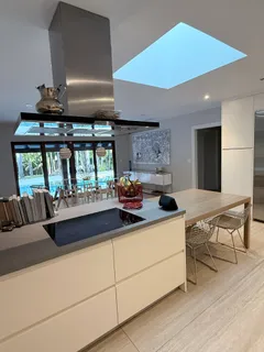 a kitchen with a stove a refrigerator and a dining table