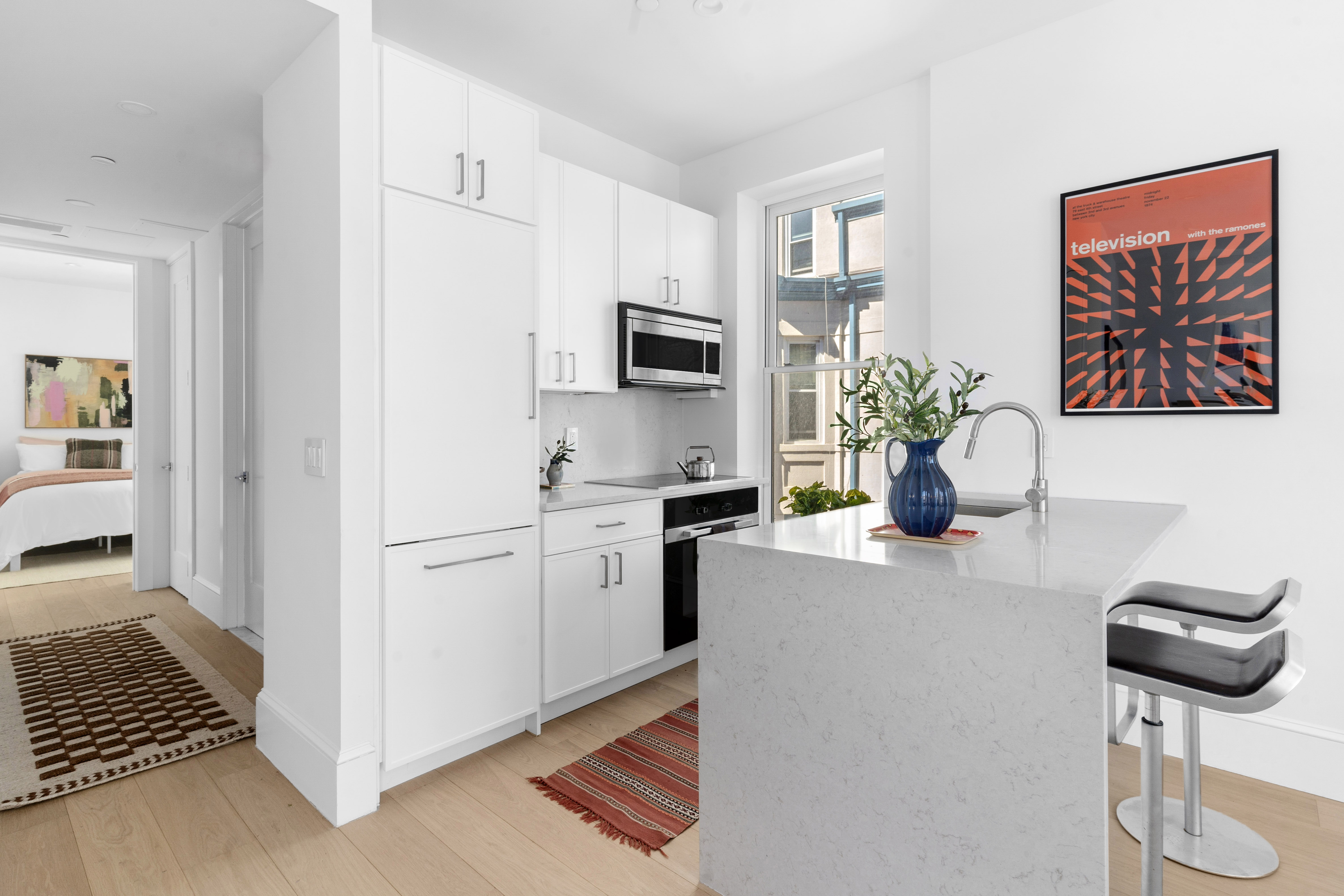 1370 Dean Street, Unit B Brooklyn, NY 11216 - Photo 3 of 8 a kitchen with stainless steel appliances granite countertop a stove a refrigerator and a microwave