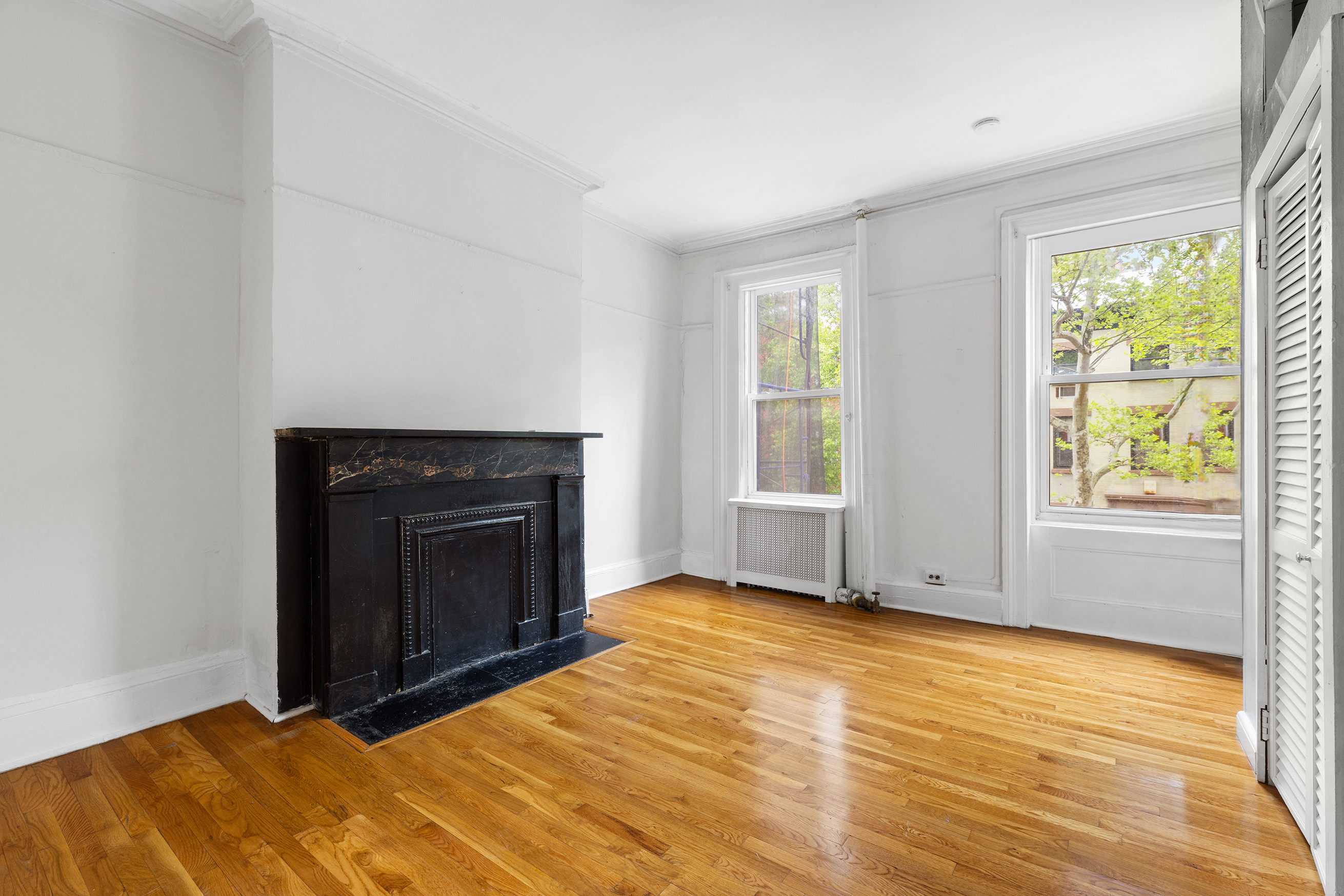 56 Joralemon Street Brooklyn, NY 11201 - Photo 15 of 18 a view of an empty room with wooden floor and a window