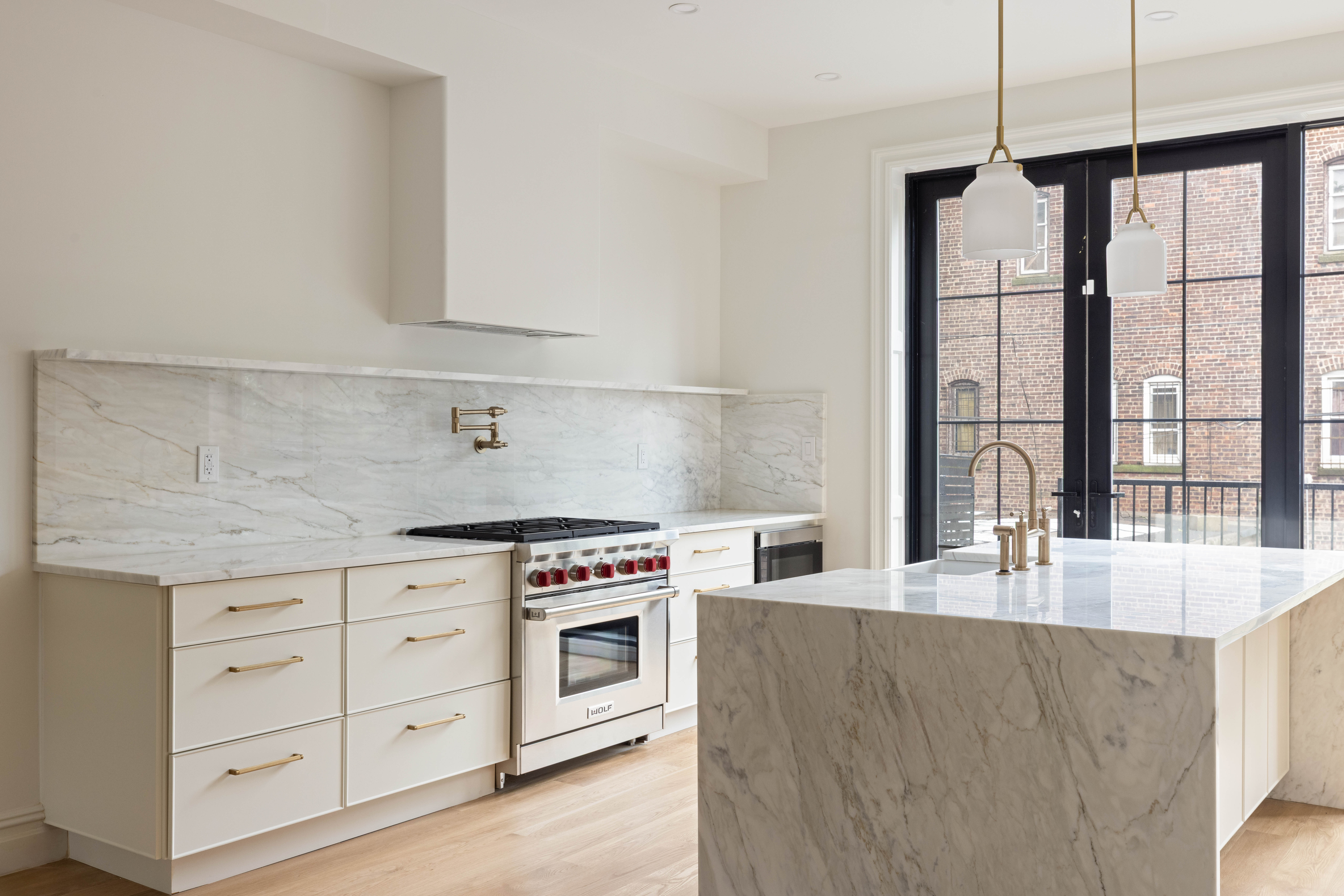 318 Halsey Street Brooklyn, NY 11216 - Photo 5 of 16 a kitchen with stainless steel appliances granite countertop a stove a sink and a white cabinets with wooden floor