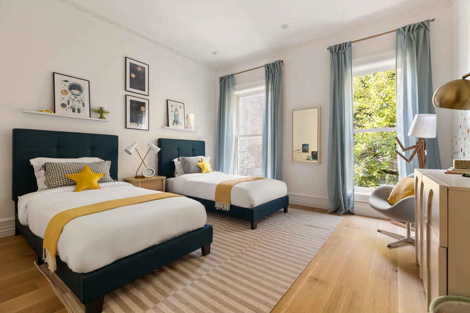 a bedroom with two beds and a large window