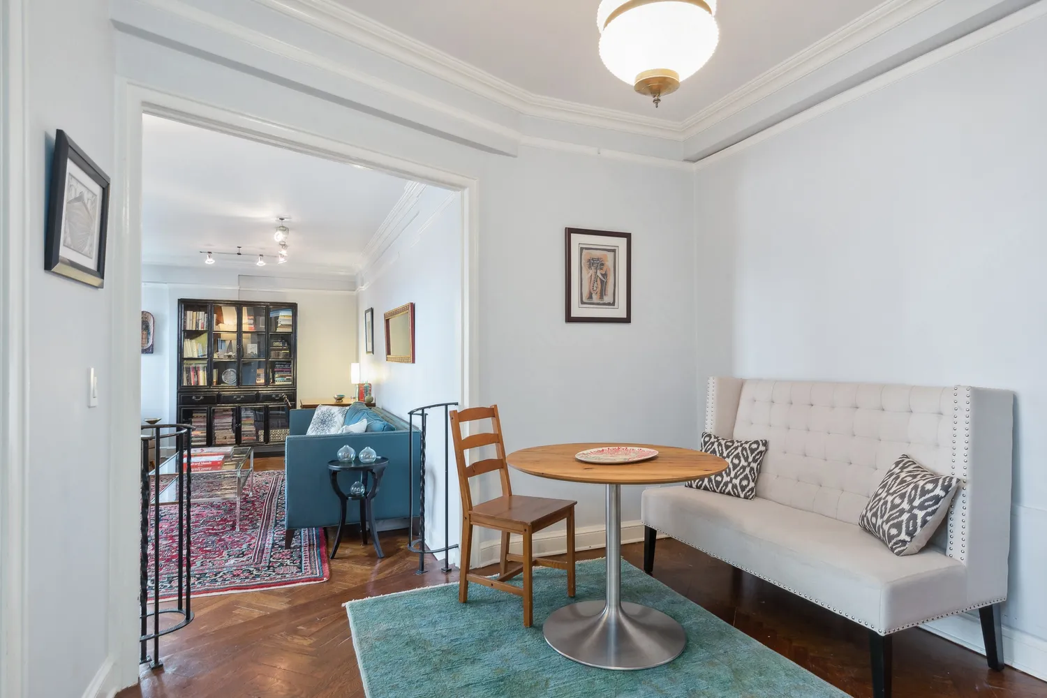 a living room with furniture a rug and a chandelier